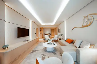 a living room with a couch and a tv at The Meydan Hotel Dubai in Dubai