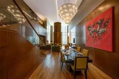 a dining room with a long table and chairs at The Meydan Hotel Dubai in Dubai