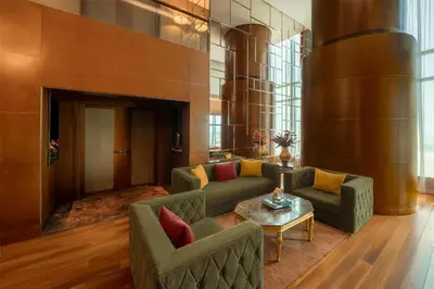 a lobby with couches and a table in a building at The Meydan Hotel Dubai in Dubai