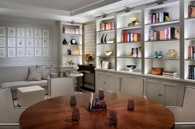 a living room with a table and chairs and a couch at Kempinski The Boulevard Dubai in Dubai