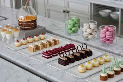 a buffet with different types of desserts and cakes at Kempinski The Boulevard Dubai in Dubai