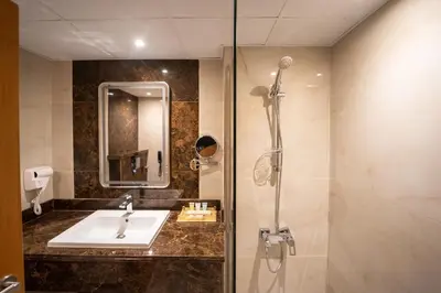 a bathroom with a sink and a shower at Smana Hotel Al Raffa in Dubai