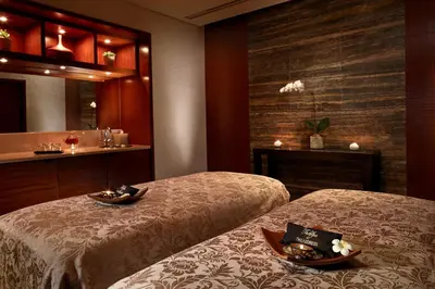 a hotel room with two beds and a mirror at Address Montgomerie in Dubai