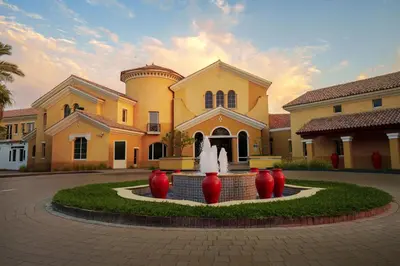 a building with a fountain in front of a building at Arabian Ranches Golf Club in Dubai