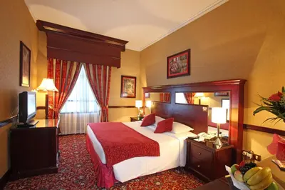 a hotel room with a bed and a television at Sea View Hotel Dubai in Dubai