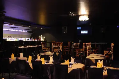 a dining room with tables and chairs and a bar at Sea View Hotel Dubai in Dubai