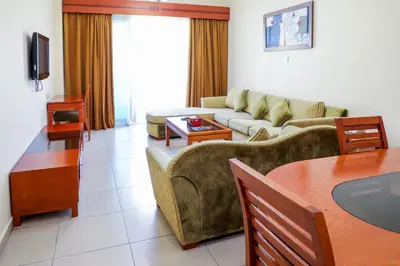 a living room with a couch and a table at Wescott Plaza Hotel Apartments LLC Formerly West Zone Plaza Hotel Apts in Dubai