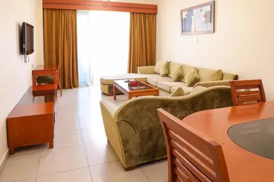 a living room with a couch and a table at Wescott Plaza Hotel Apartments LLC Formerly West Zone Plaza Hotel Apts in Dubai