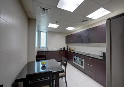 a large kitchen with a table and chairs in it at Marina Hotel Apartments in Dubai