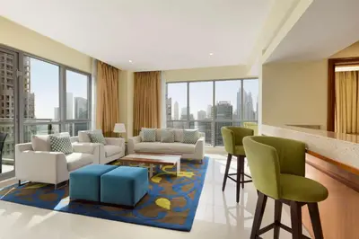 a living room with a view of a city at Ramada by Wyndham Downtown Dubai in Dubai
