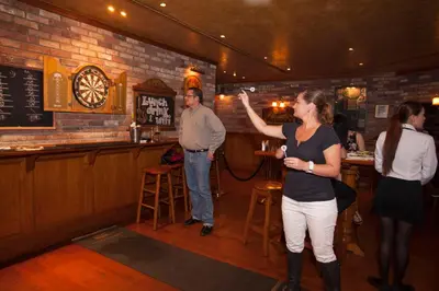 a woman standing in a bar with a man at Social Hotel in Dubai