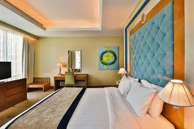 a hotel room with a bed and a television at Social Hotel in Dubai