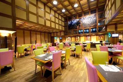 a dining room with tables and chairs in a restaurant at Capitol Hotel Jumeirah Dubai in Dubai