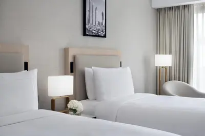 a hotel room with two beds and two lamps at JW Marriott Hotel Marina in Dubai