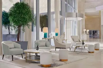 a lobby with chairs and a table and a tree at JW Marriott Hotel Marina in Dubai