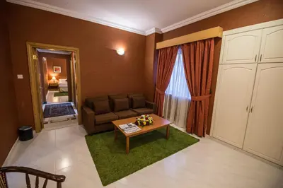 a living room with a couch and a table at Welcome Hotel Apartments 1 in Dubai