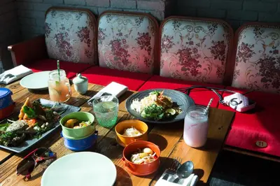 a wooden table with plates of food on it at Naumi Hotel Dubai in Dubai