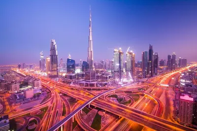 a busy freeway in a large city at night at Naumi Hotel Dubai in Dubai