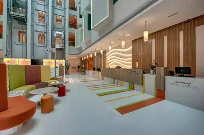 a lobby of a building with colorful chairs and tables at Al Khoory Atrium in Dubai