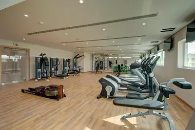 a gym with treadmills and ellipticals in a room at Al Khoory Atrium in Dubai