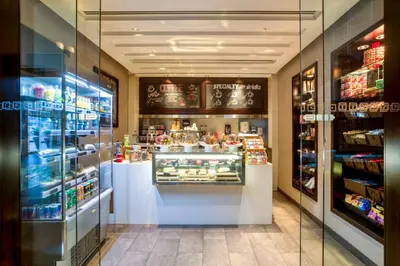 a bakery with a display case in a store at Centro Barsha - by Rotana in Dubai
