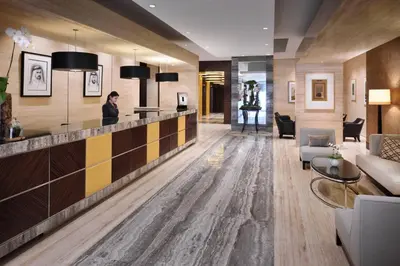 a lobby of a hotel with a woman standing at a counter at Dubai Marriott Harbour Hotel And Suites in Dubai