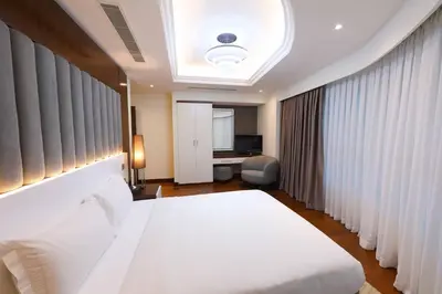 a bedroom with a large white bed in a room at Number One Tower Suites in Dubai