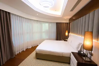 a bedroom with a bed and a large window at Number One Tower Suites in Dubai