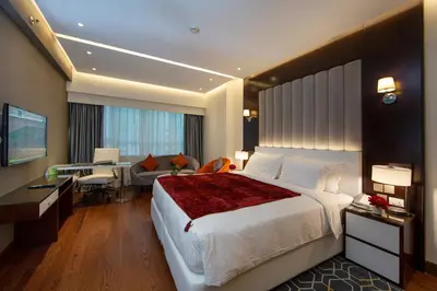 a hotel room with a large bed and a desk and a desk at Number One Tower Suites in Dubai