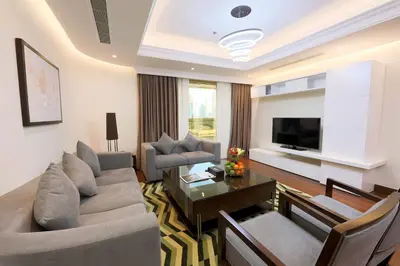 a living room with a couch and a table at Number One Tower Suites in Dubai