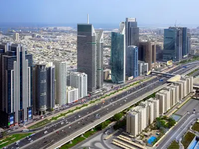 an aerial view of a large city with traffic at The Apartments, Dubai World Trade Centre in Dubai