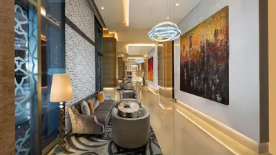a lobby of a hotel with a large painting on the wall at Aspen Chalets by Kempinski Hotel Mall of The Emirates in Dubai