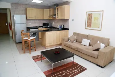 a living room with a couch and a table at Armada Living - Holiday Homes Rental in Dubai