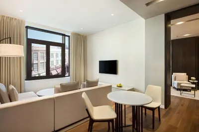 a living room with a table and chairs at La Ville Hotel & Suites CITY WALK Dubai, Autograph Collection in Dubai