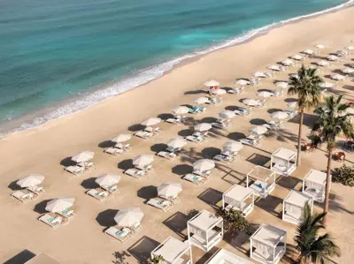 an overhead view of a beach with chairs and umbrellas at Nikki Beach Resort & Spa Dubai in Dubai