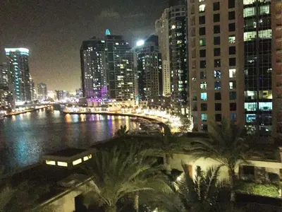 a view of a city at night with a bridge at My-Places Dubai Apartment suitable for large groups Al Sahab 1 in Dubai
