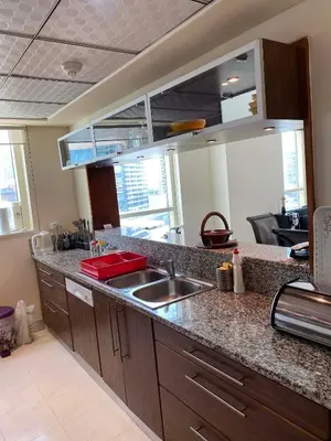 a kitchen with a sink and a counter top at My-Places Dubai Apartment suitable for large groups Al Sahab 1 in Dubai