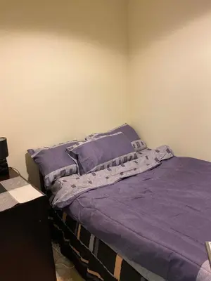 a bedroom with a bed with purple sheets and pillows at My-Places Dubai Apartment suitable for large groups Al Sahab 1 in Dubai