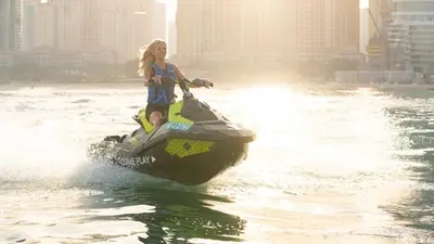 a girl is riding a jet ski in the water at FIVE Palm Jumeirah Dubai in Dubai