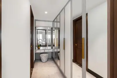 a hallway with a mirror and a bathroom with a sink at Al Habtoor Polo Resort in Dubai