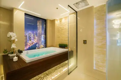 a bathroom with a soaking tub with a window at Princess Tower Dubai Marina private Spa amazing view in Dubai