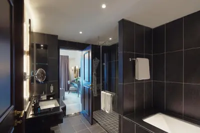 a bathroom with a sink and a bath tub at Dukes The Palm Dubai Hotel in Dubai