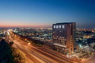 a view of a city at night with a building at Rove Trade Centre in Dubai