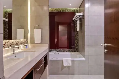 a bathroom with a tub and a sink and a shower at Radisson Blu Hotel, Dubai Waterfront in Dubai