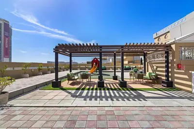 a playground with a slide in a gazebo at Al Khoory Hotel Apartments Al Barsha in Dubai