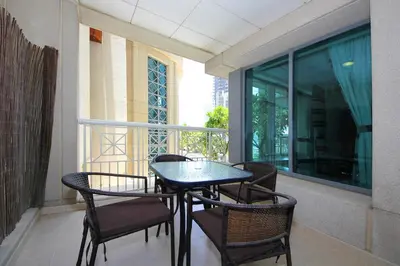 a balcony with a table and chairs and a window at New Arabian 29 Boulevard Downtown in Dubai