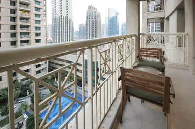 a balcony with a bench and a view of a city at New Arabian 29 Boulevard Downtown in Dubai