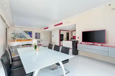 a dining room with a table and chairs and a tv at JBR Luxury Penthouse with private pool, cinema, gym, spa etc in Dubai