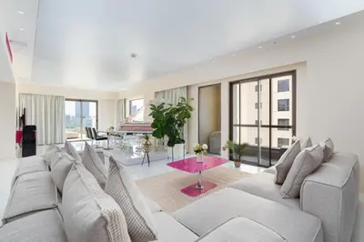 a living room with a large couch and a table at JBR Luxury Penthouse with private pool, cinema, gym, spa etc in Dubai