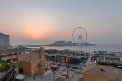 a view of a city with a ferris wheel in the background at Elan Rimal2 Suites in Dubai